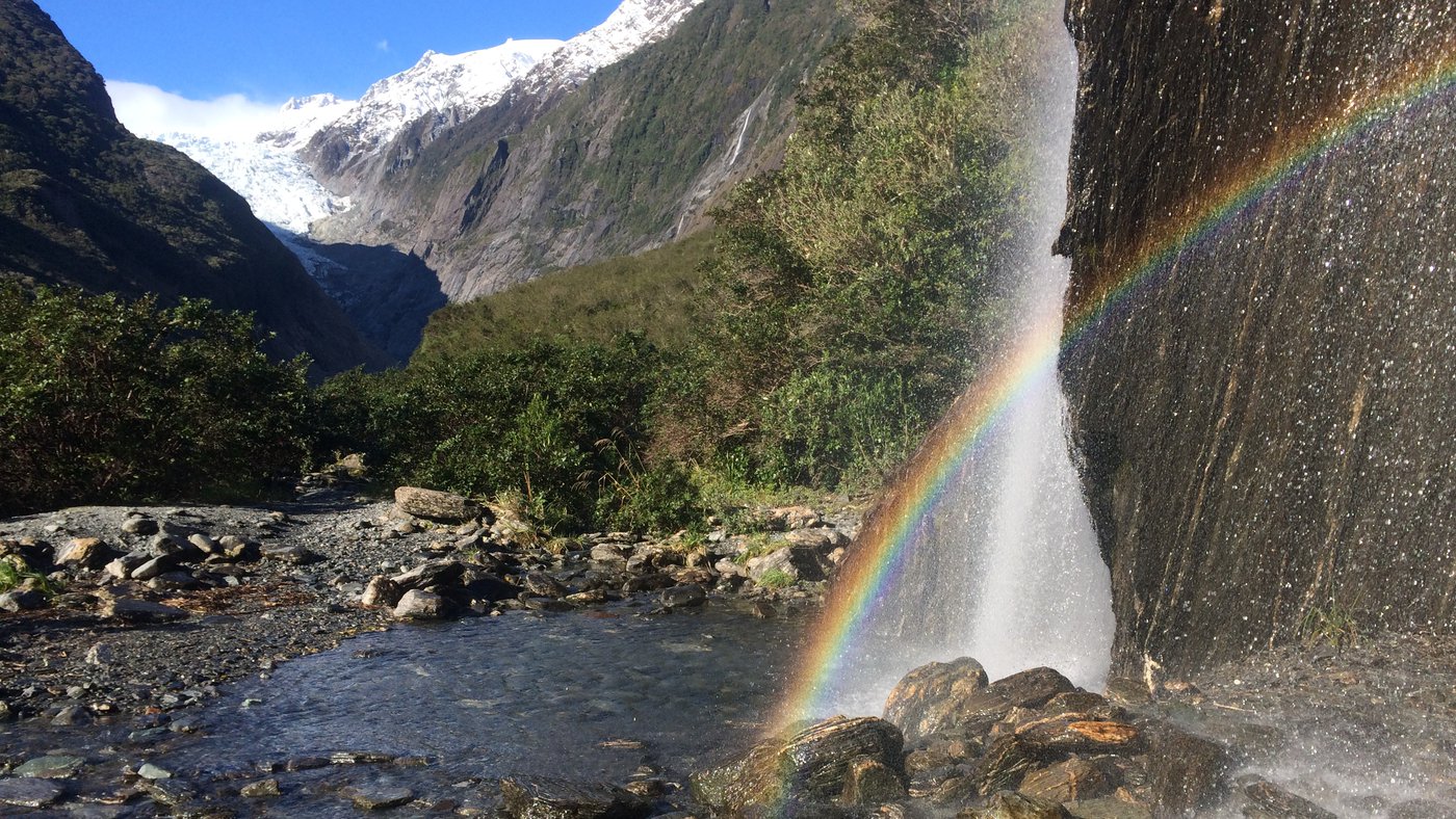 Rainbows in Trident Falls waterfall in the Franz Josef Glacier Valley