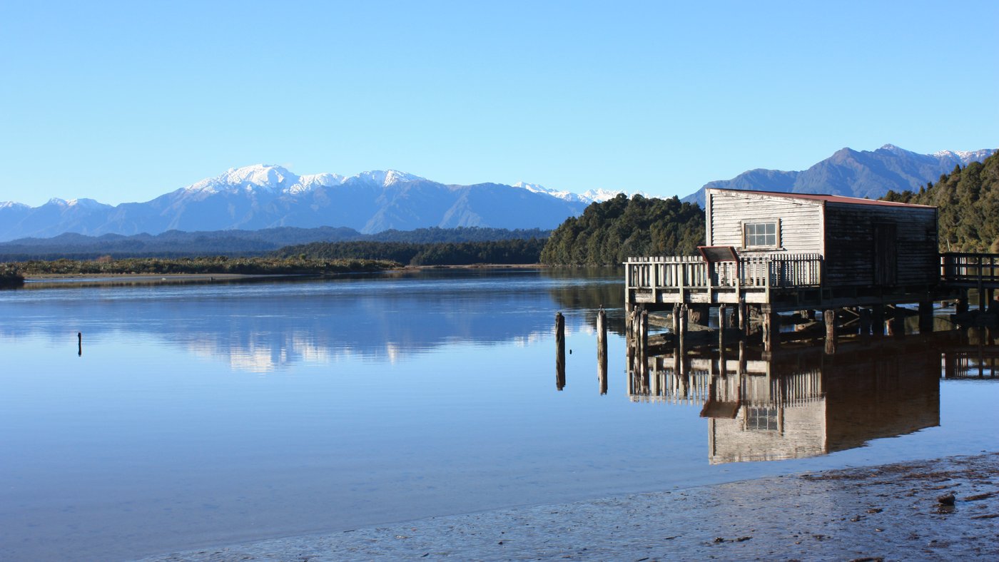 Historic Okarito Wharf shed & Mt Adams. Okarito South Westland NZ.