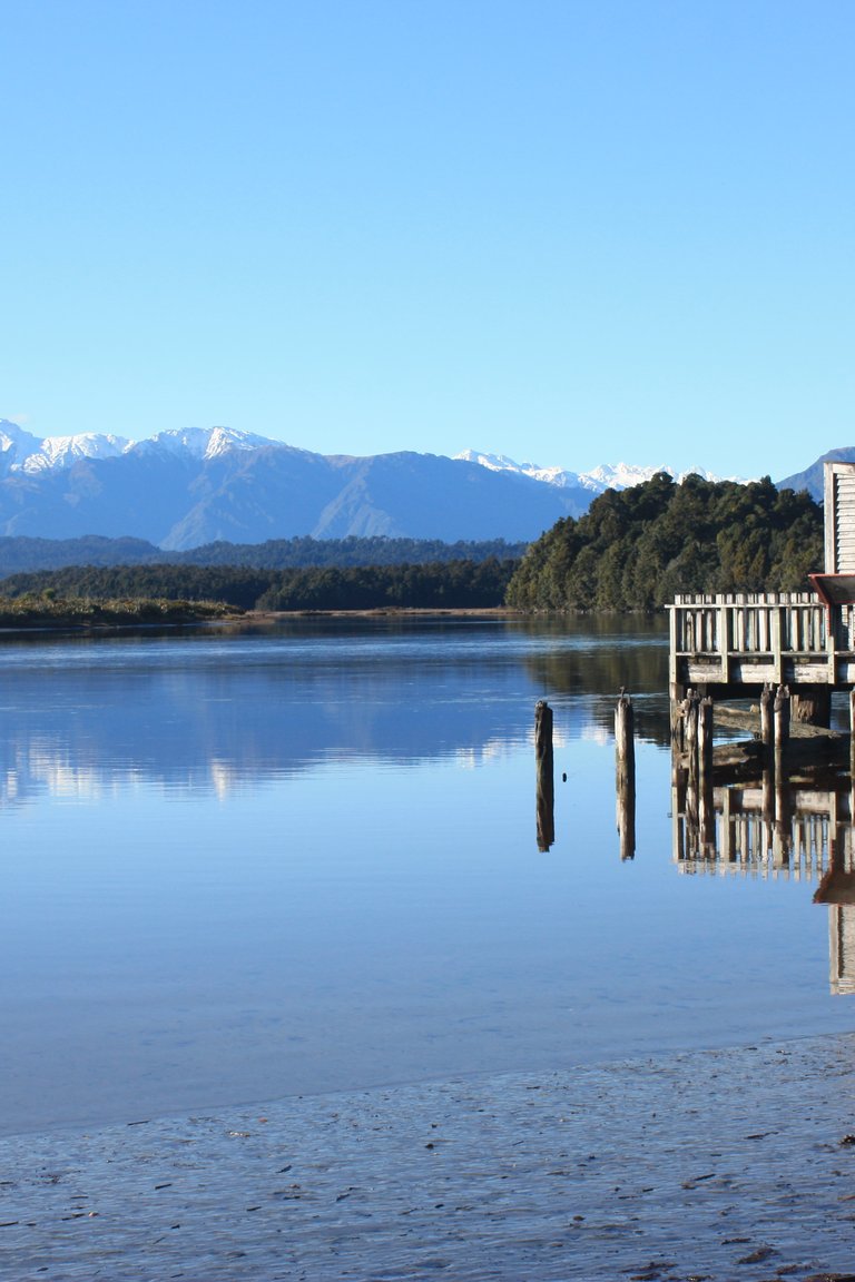 Historic Okarito Wharf shed & Mt Adams. Okarito South Westland NZ.