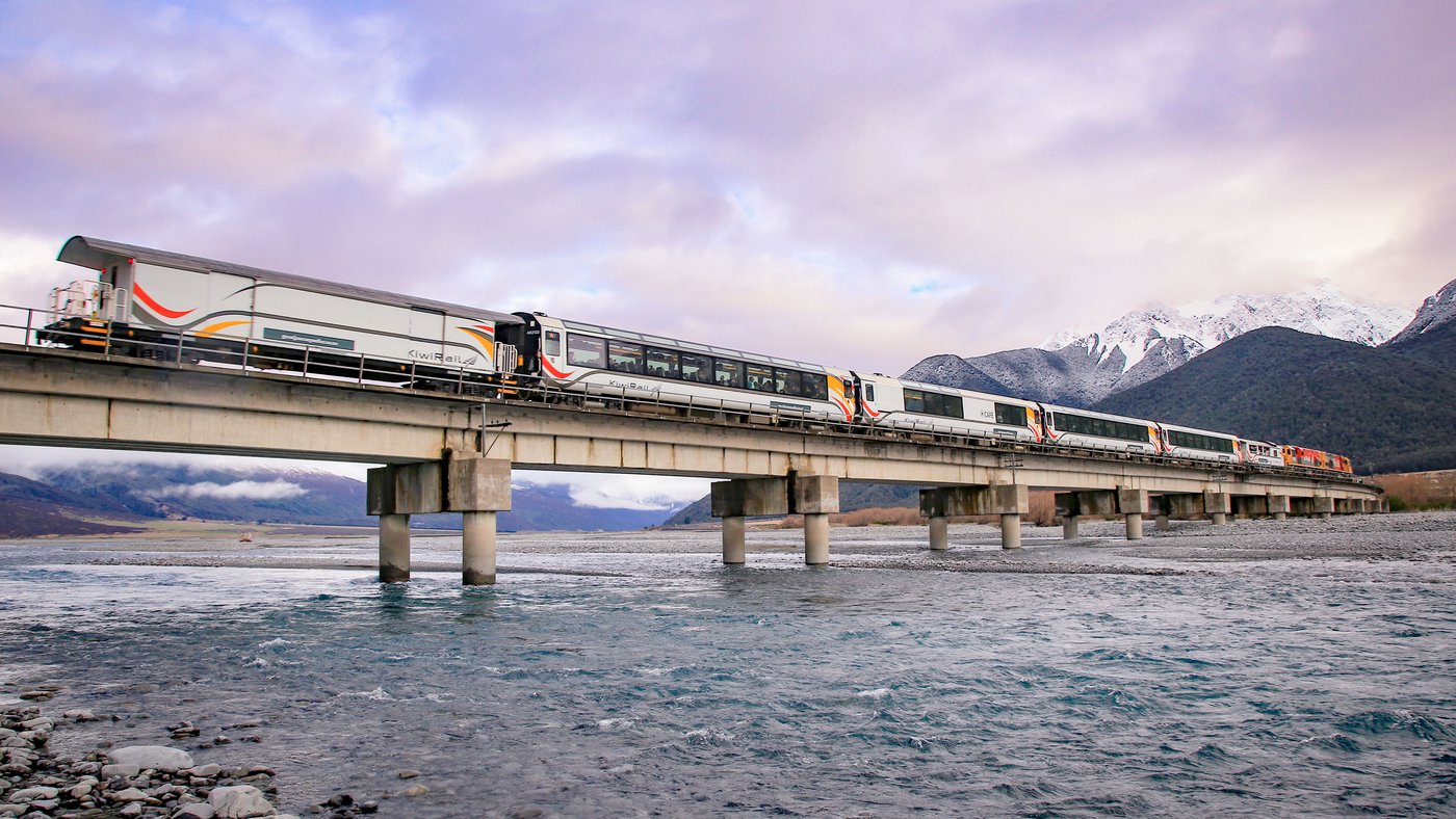 TranzAlpine train crossing a wintry Waimakariri River high in the Southern Alps near Cass.